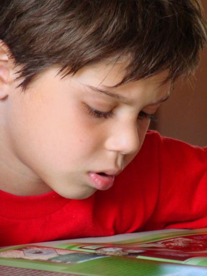 boy reading red shirt